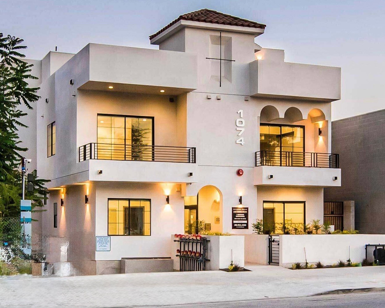 1074 — white multi-family with arched entrance